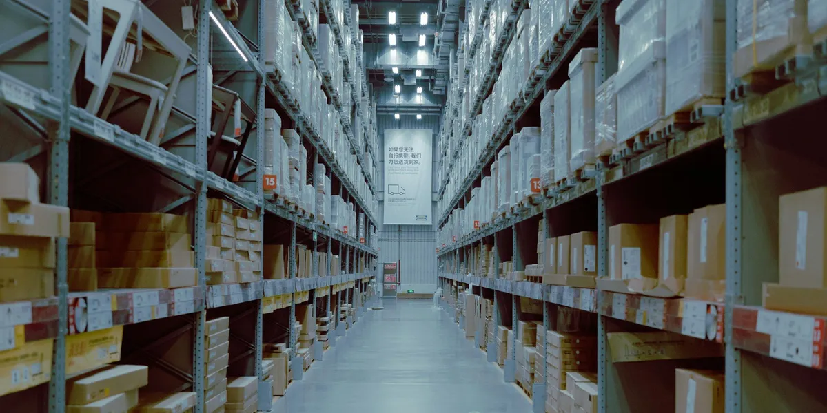 Large warehouse with rows of inventory shelves and pallets