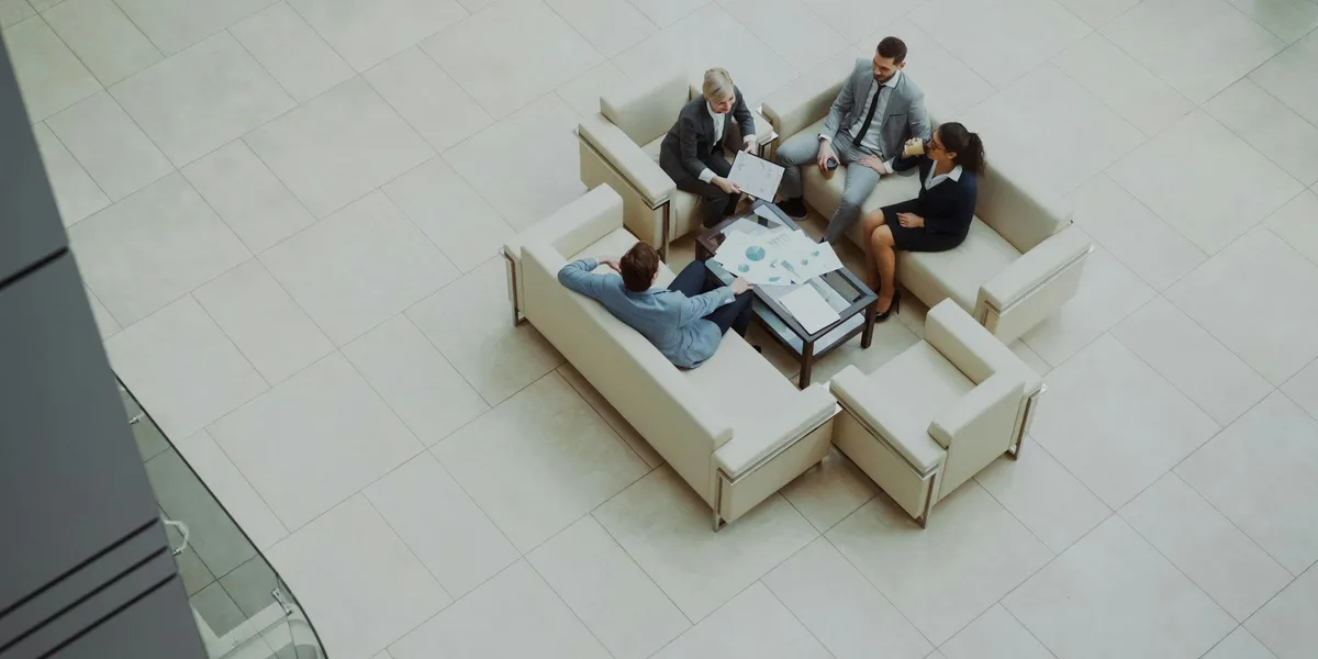 Business professionals meeting in a modern office lobby