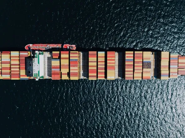 Aerial view of a container ship loaded with stacked containers at sea