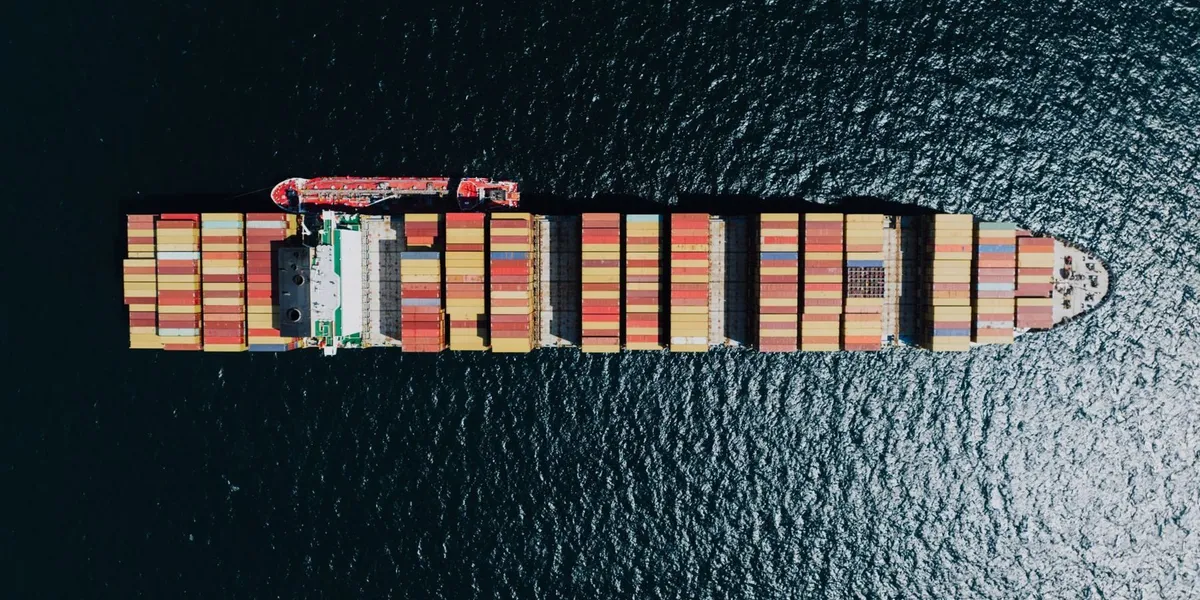 Aerial view of a container ship loaded with stacked containers at sea