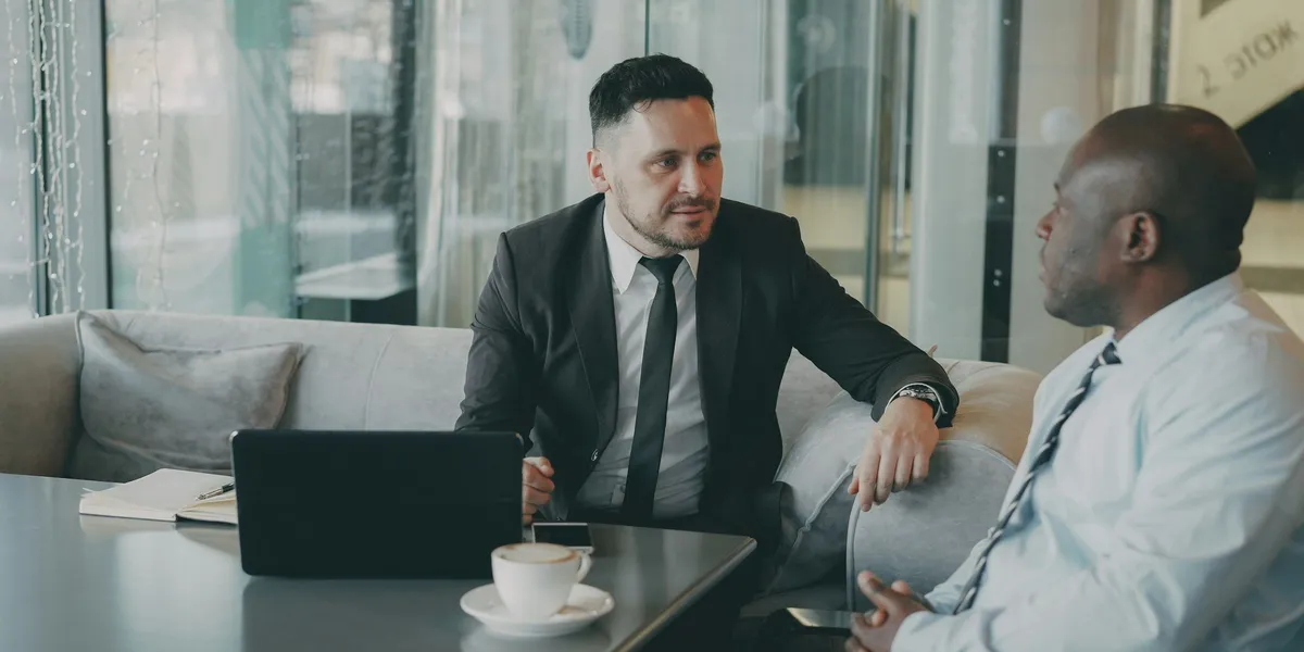 Two business professionals reviewing financial benchmarks on a laptop