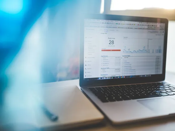 Laptop displaying Google Analytics in a modern workspace, highlighting digital analytics and technology.