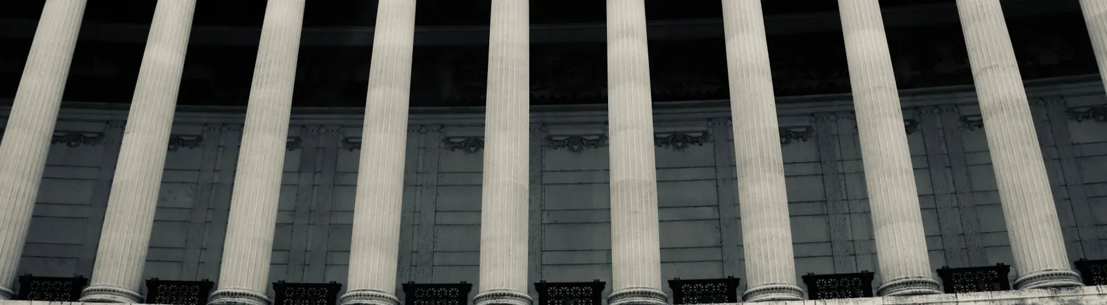 Detailed view of neoclassical columns in a government building facade.