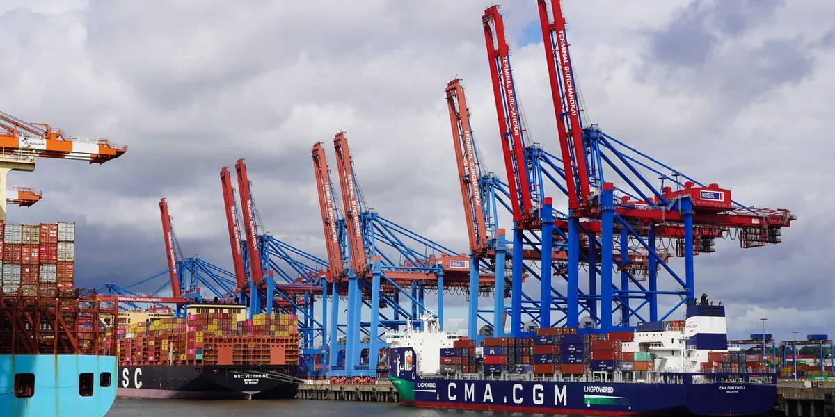 Container ships and cranes at the bustling Hamburg port, showcasing global trade activity.