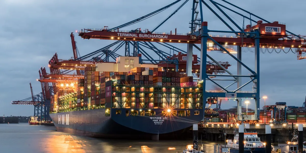 Container ships moored at Terminal Burchardkai in Hamburg, Germany during evening hours.