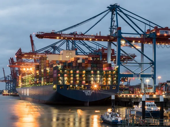 Container ships moored at Terminal Burchardkai in Hamburg, Germany during evening hours.