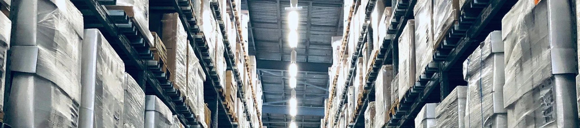 Wide angle view of a modern logistics warehouse interior with stacked pallets