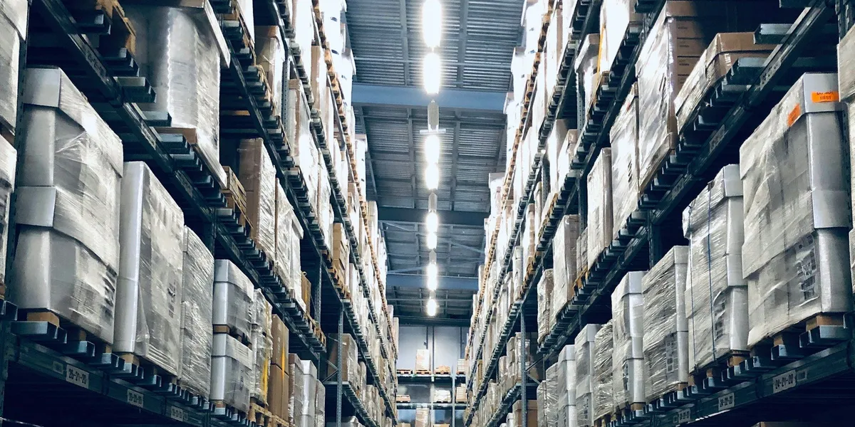 Wide angle view of a modern logistics warehouse interior with stacked pallets
