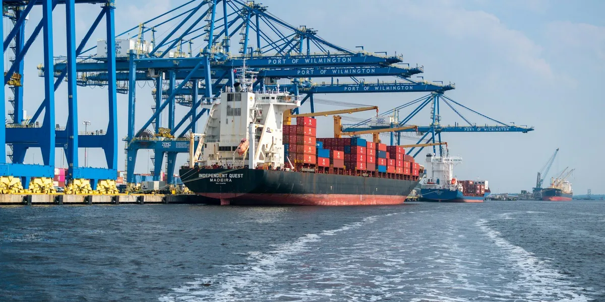 Cargo ship and cranes at a terminal representing port logistics marketing