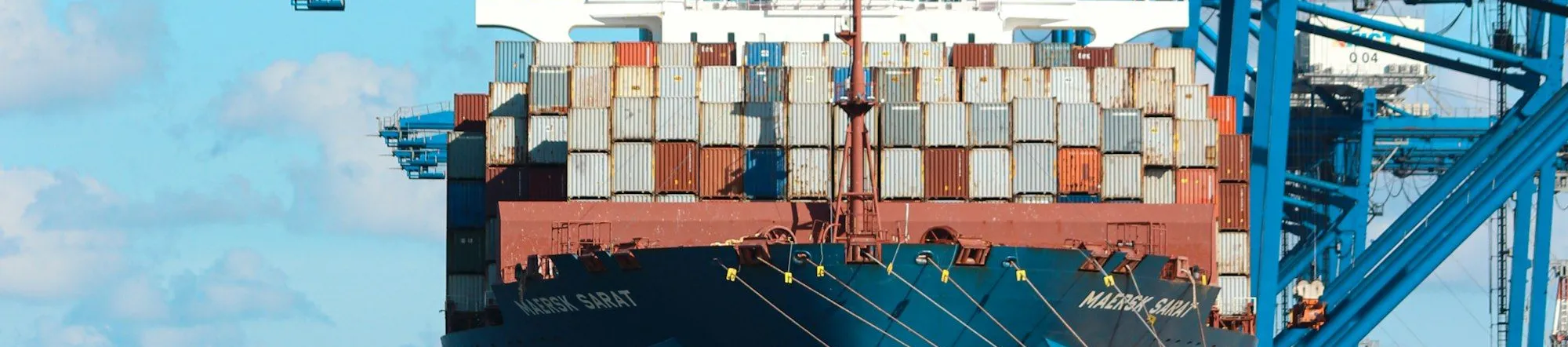 Container ship docked at a freight port at dusk