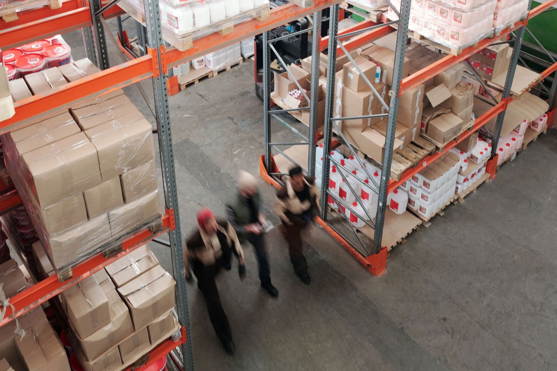 Workers moving through a fulfillment warehouse